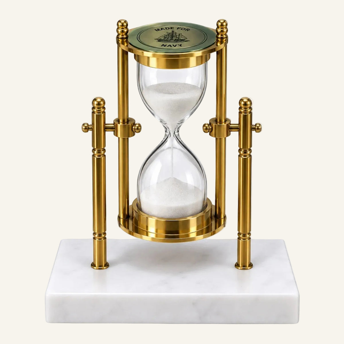 A decorative brass hourglass with a white marble base, featuring a clear glass hourglass filled with white sand and a green top cap.