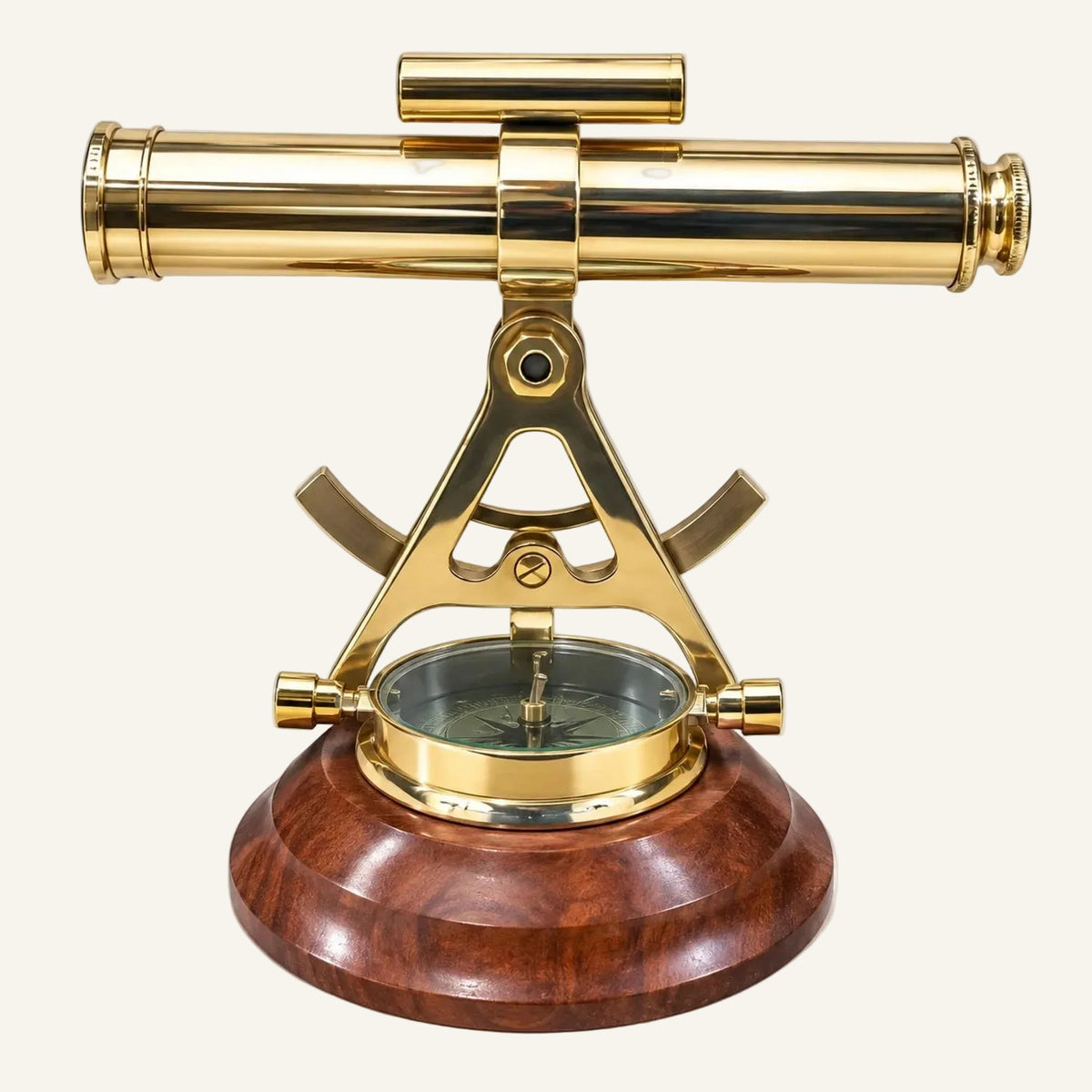 A brass marine surveyor's transit and compass set on a polished dark wood base, photographed against a solid white background.